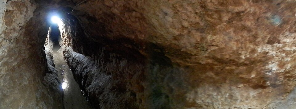 Inside a qanat tunnel near Isfahan, photographed in 2012. The surviving infrastructure carries Iranian hydraulic expertise across eras.