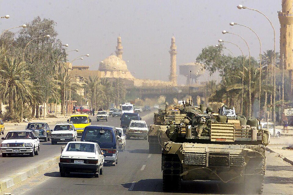 US Marine tanks patrol Baghdad in April 2003. The image was taken by the occupying military, whose viewpoint must be kept in mind.